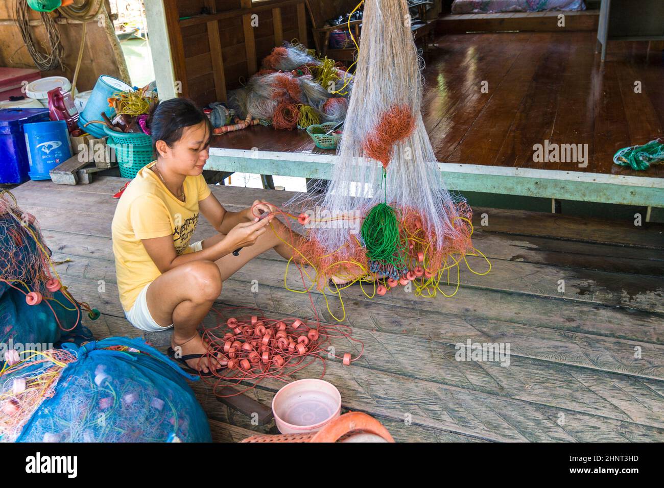 local woman cleans the fishing net Stock Photo