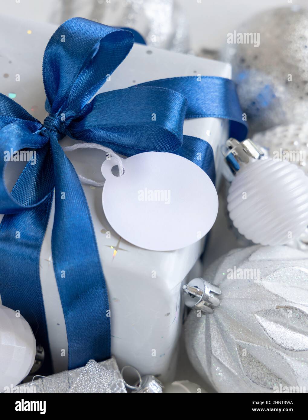 wrapped-present-with-a-blue-bow-and-paper-gift-tag-with-white-blue-and