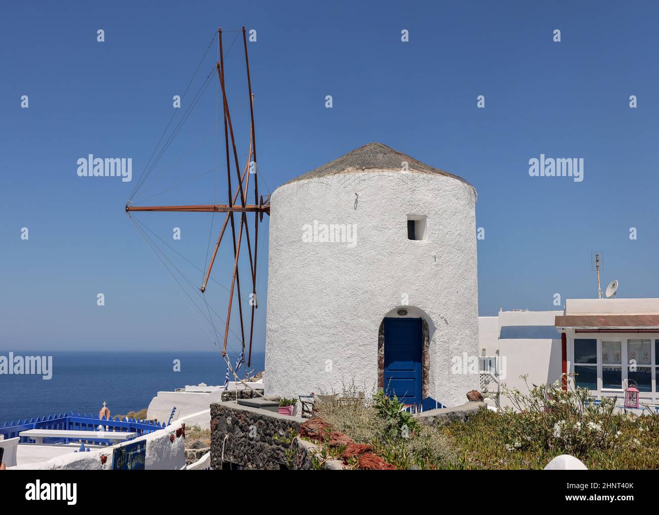 Traditional white windmill in Oia on Santorini. Stock Photo