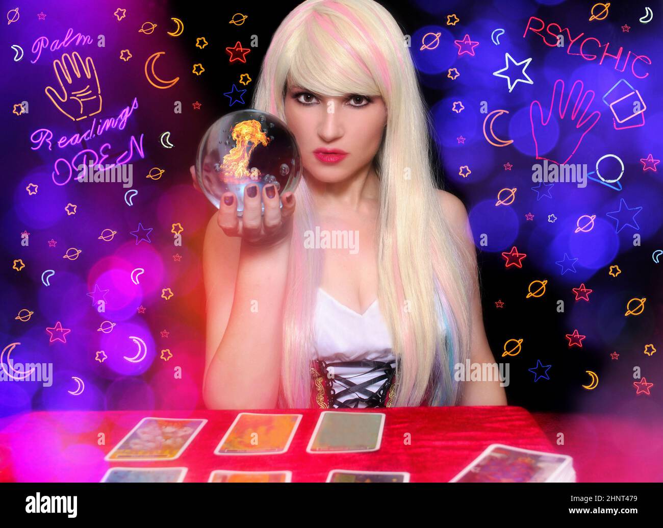 Psychic with Blond hair and Crystal Ball. Neon Lights in background Stock Photo