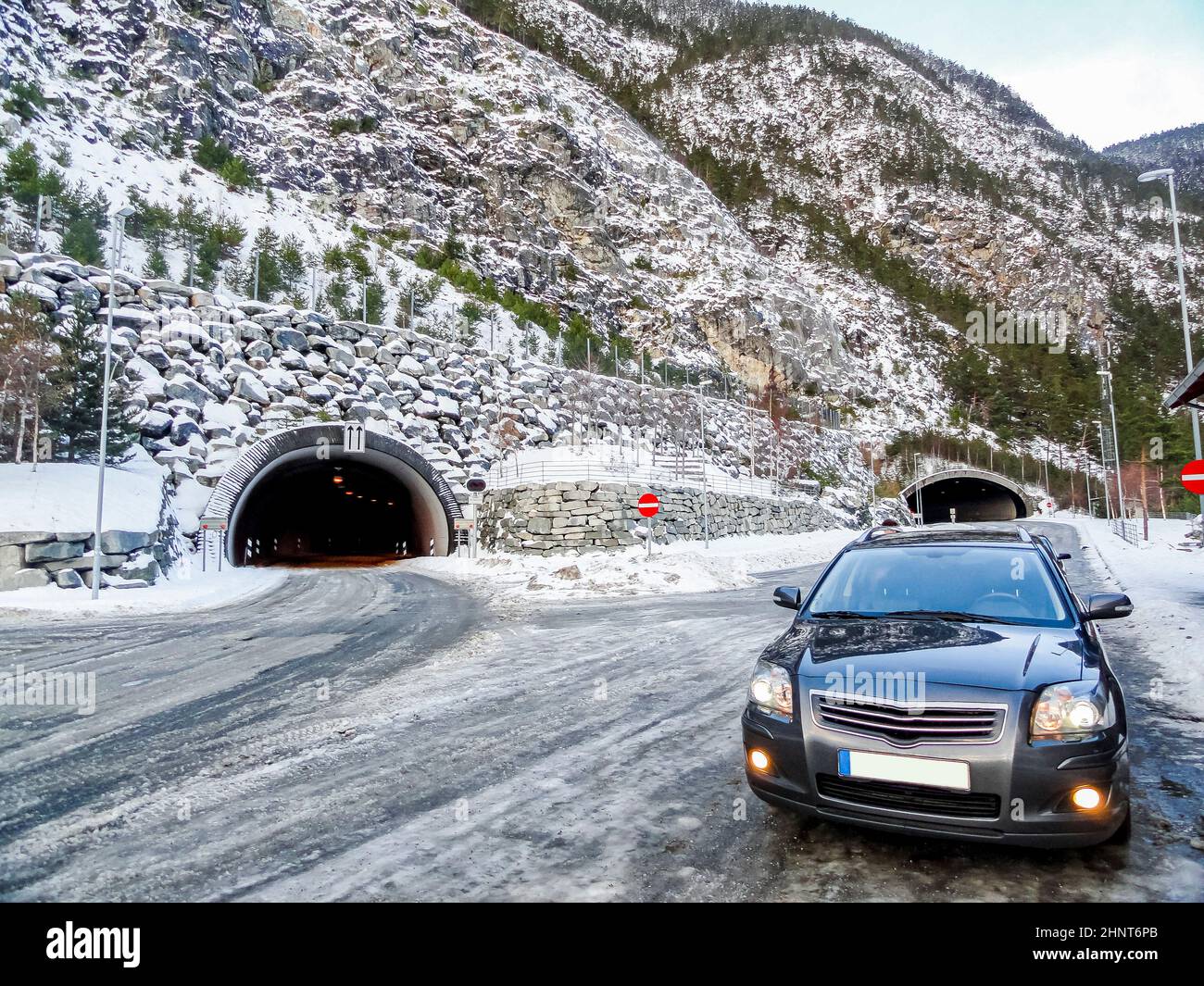 Car in front of a tunnel in winter landscape of Norway. Stock Photo
