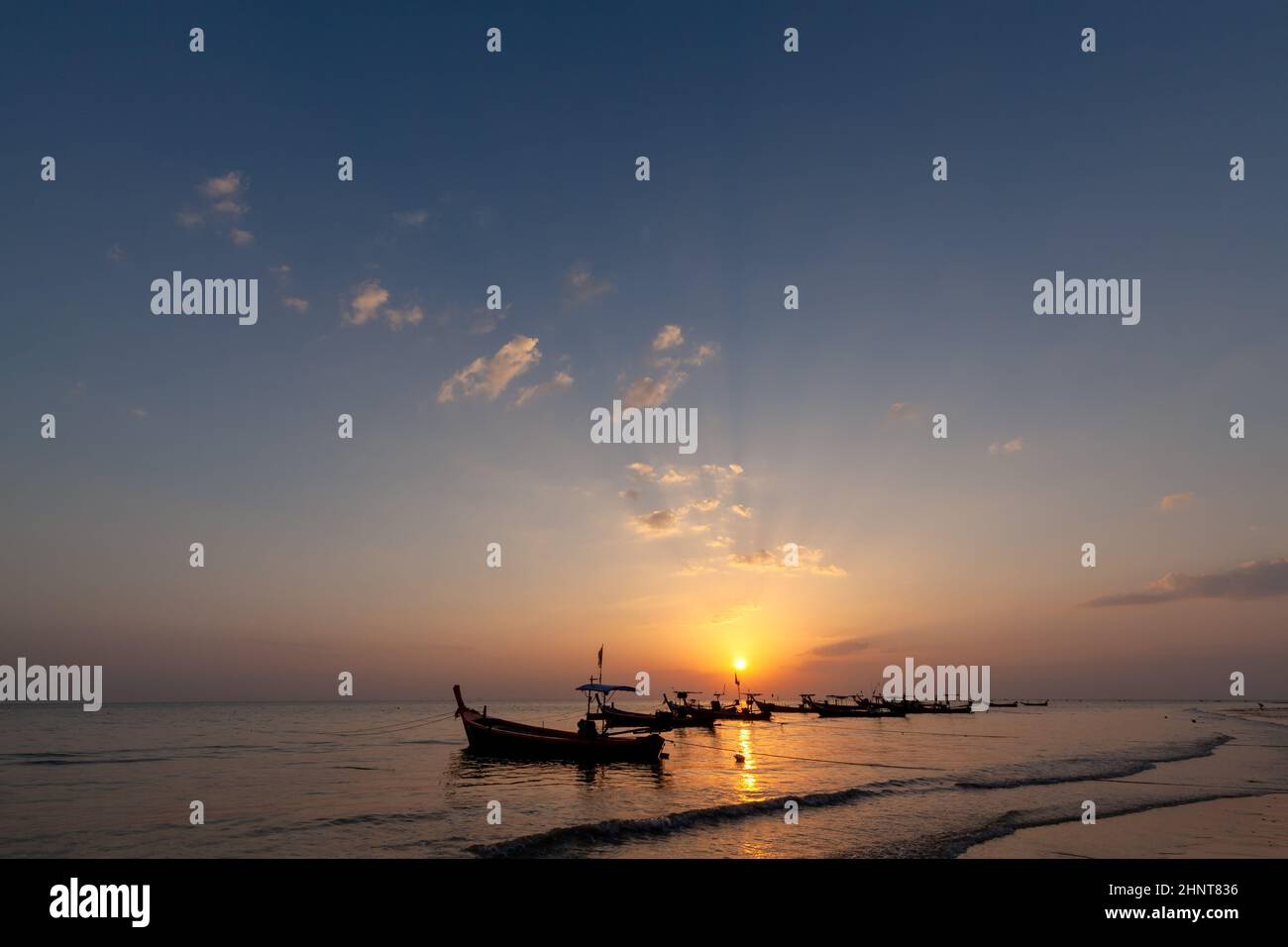 Lanscape of longtail boat in evening time with sunray beam Stock Photo