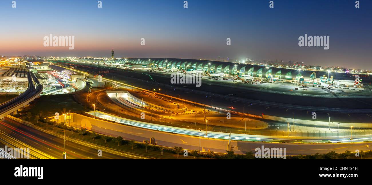 Overview Dubai International Airport Terminal DXB panorama at night in the United Arab Emirates Stock Photo