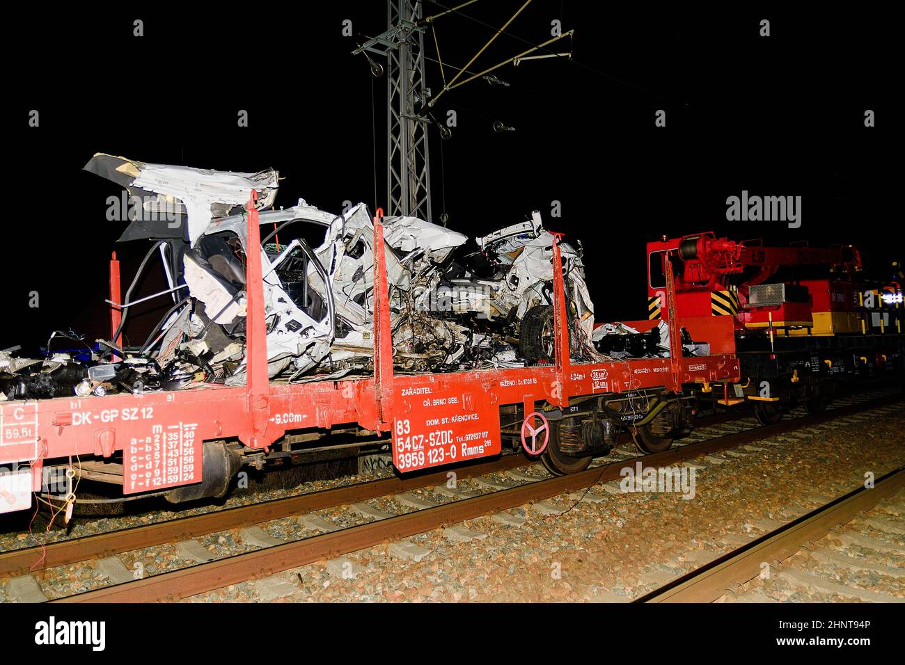 The crashed car is transported away. Real car crash with train. The woman driver is dead Stock Photo