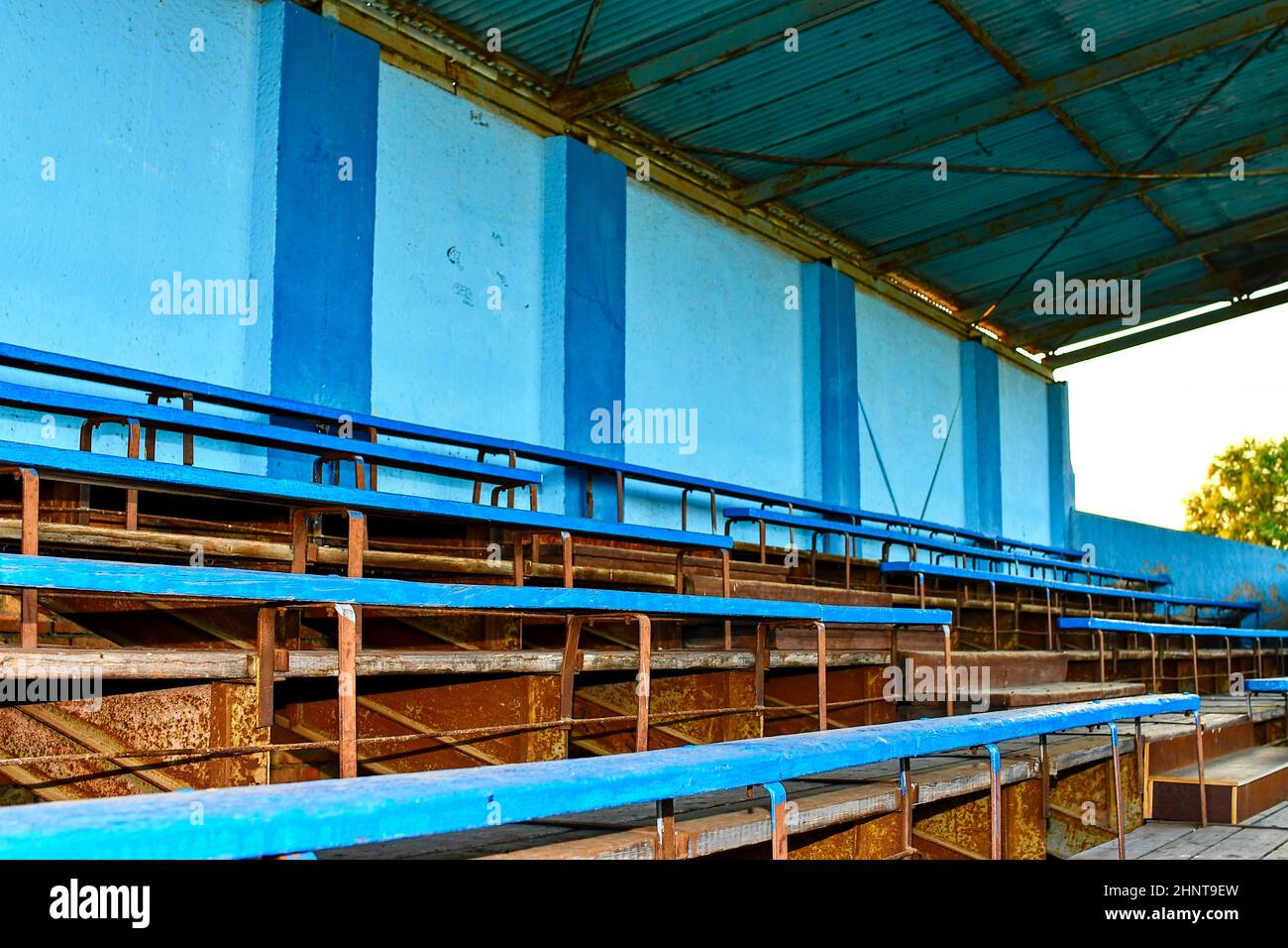 Old grandstand seats. Vintage tone. Old blue wooden grandstand stadium