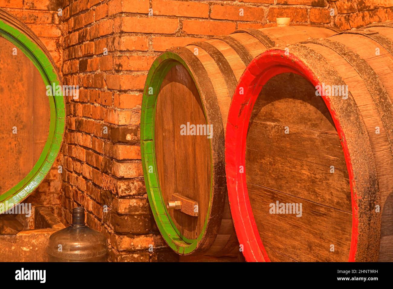 Wine barrels stacked in the old cellar of the winery. Barrels of wine