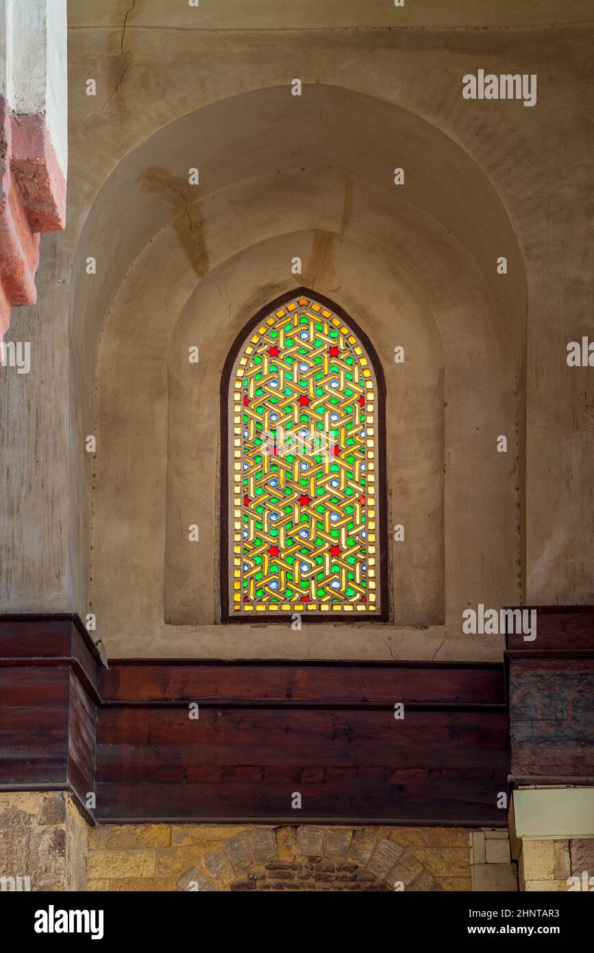 Mamluk era perforated stucco window with colorful stain glass with geometrical and floral patterns, Qalawun Complex Stock Photo
