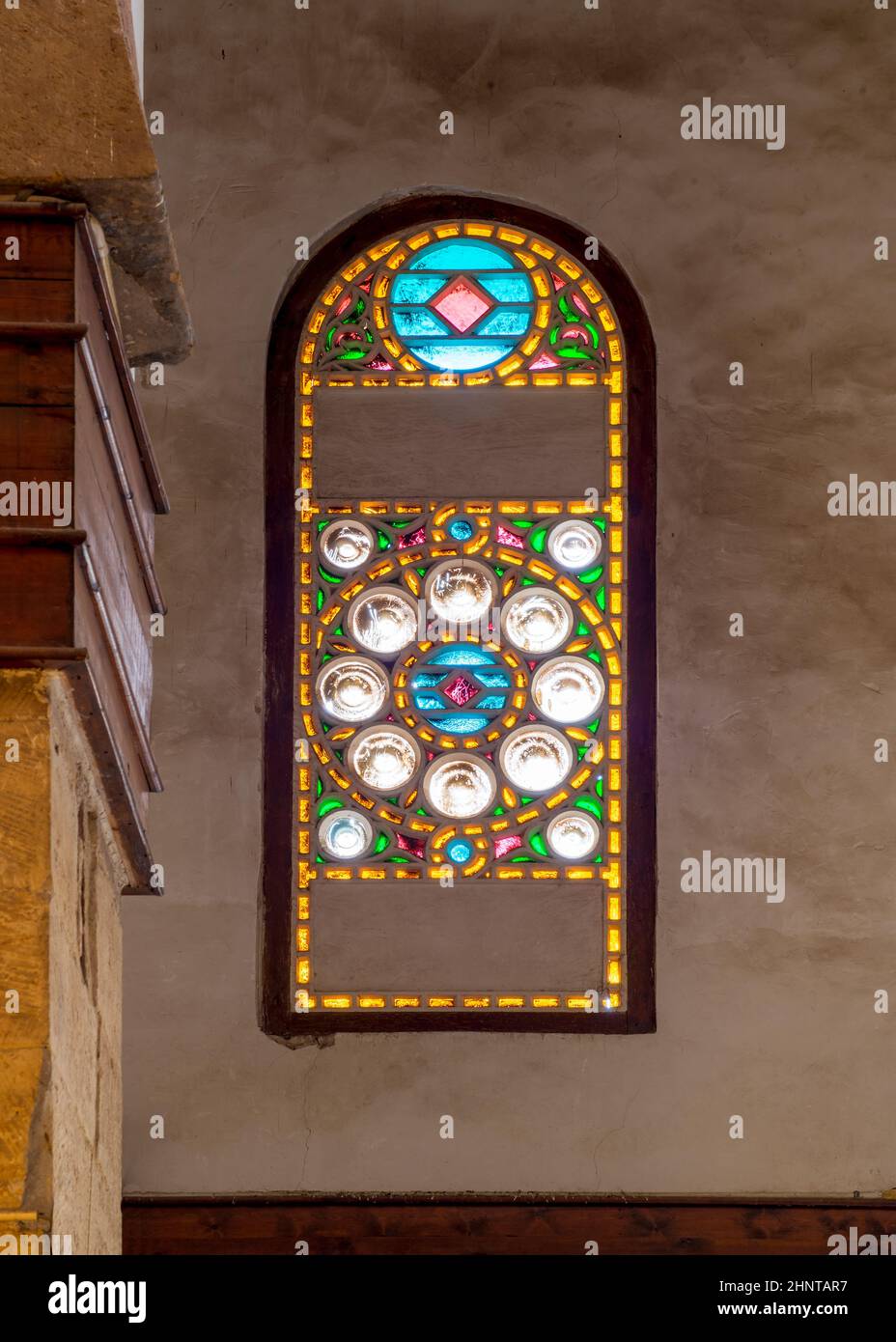 Mamluk era perforated stucco window with colorful stain glass with circular geometrical patterns, Beshtak Palace Stock Photo