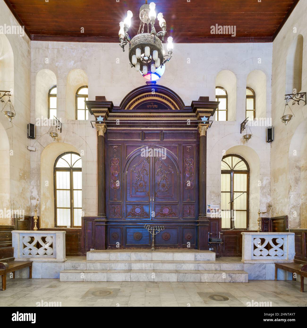 Wooden decorated entrance of historic Jewish Maimonides Synagogue with arched windows and chandelier, Cairo Egypt Stock Photo