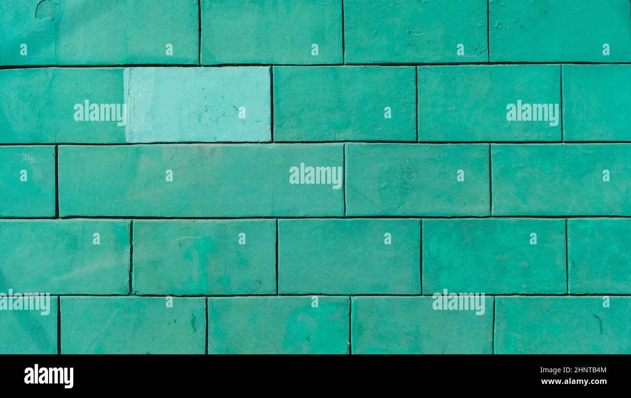 Brick wall is painted mint green color. stone background Stock Photo