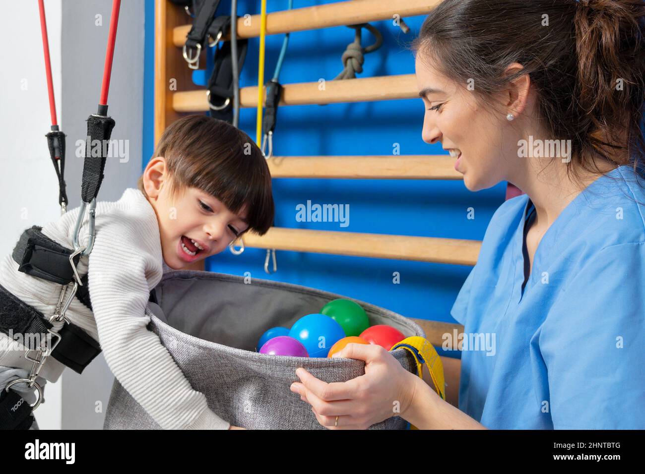 Disabled child is playing, learning and exercising in rehabilitation therapy hospital, Lifestyle of a child with disability. Happy disability kid concept. Stock Photo