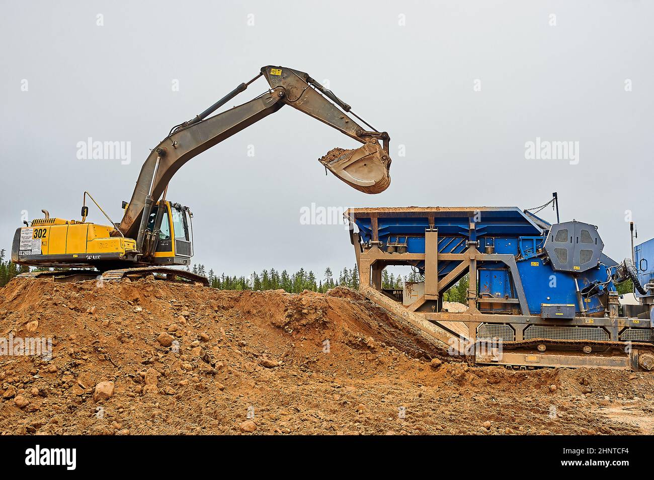 The excavator in the quarry digs sand Stock Photo Alamy