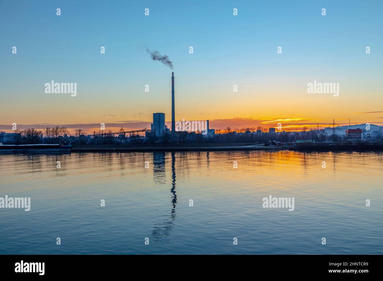 industry at river Danube in Linz, Austria in sunset with smog Stock Photo
