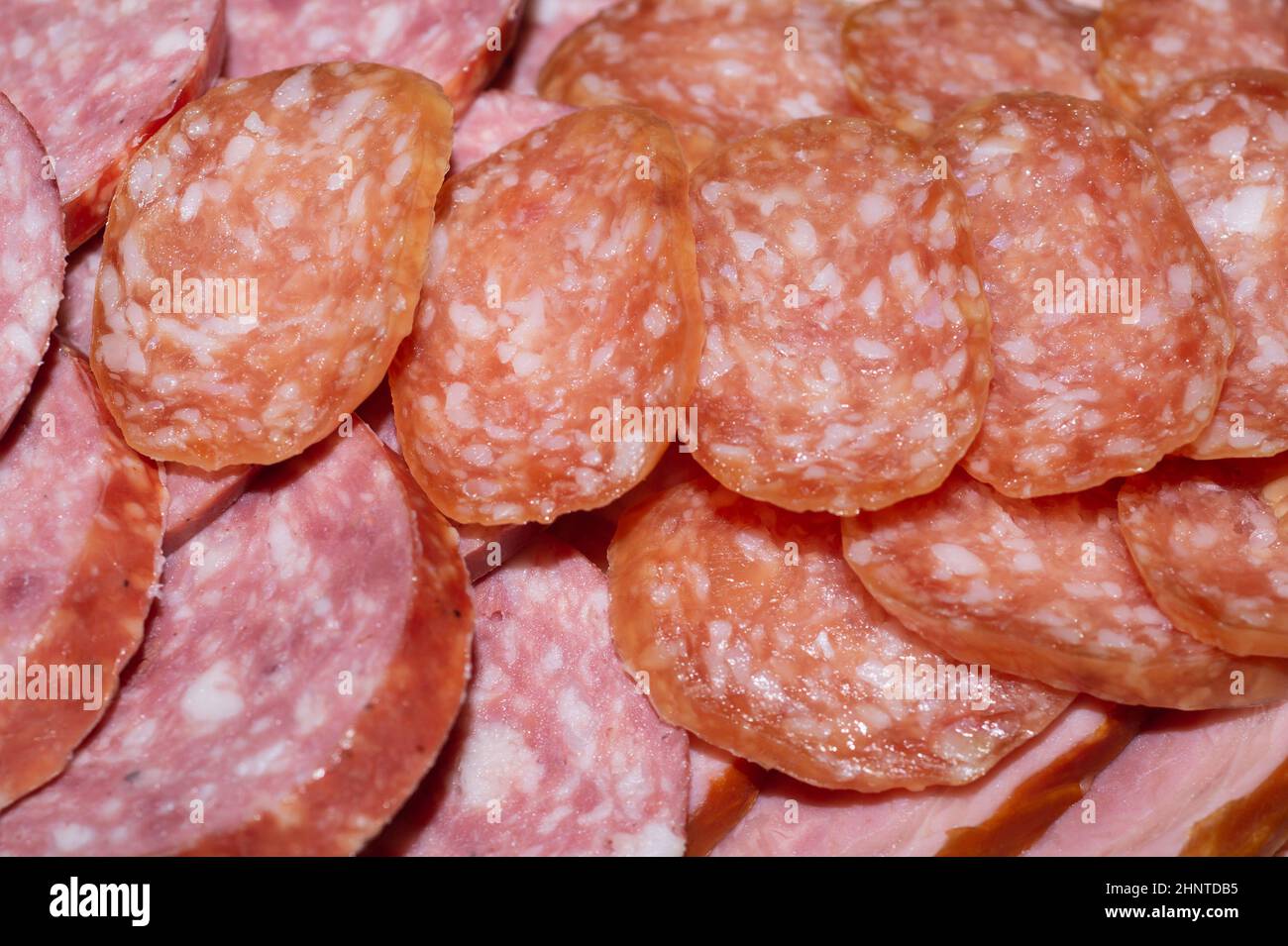 Salami background. many sliced pieces of sausage Stock Photo Alamy