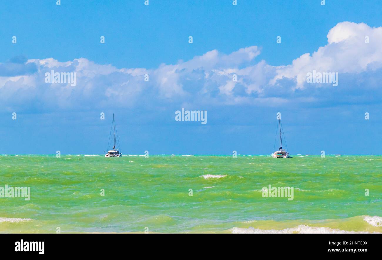 Beautiful Holbox island beach turquoise water waves and boats Mexico. Stock Photo