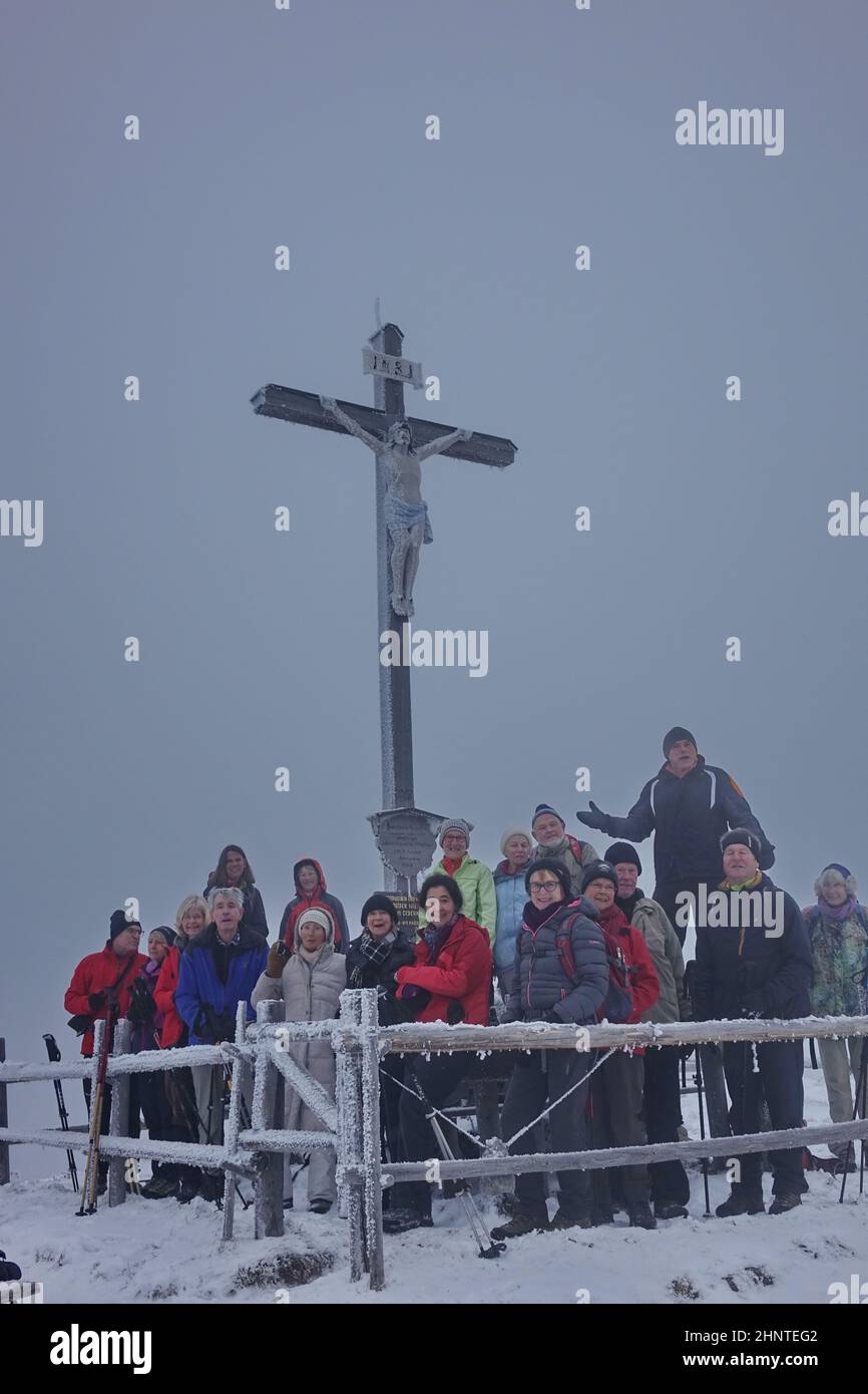 Bavaria, Upper Bavaria, hiking groupe, Schwarzenberg mountain, Summit cross, Frost, Snow, Winter Stock Photo