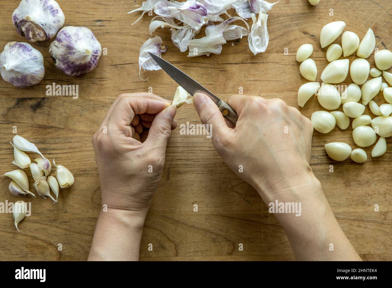 An overview of peeling a clove of garlic with a knife Stock Photo Alamy