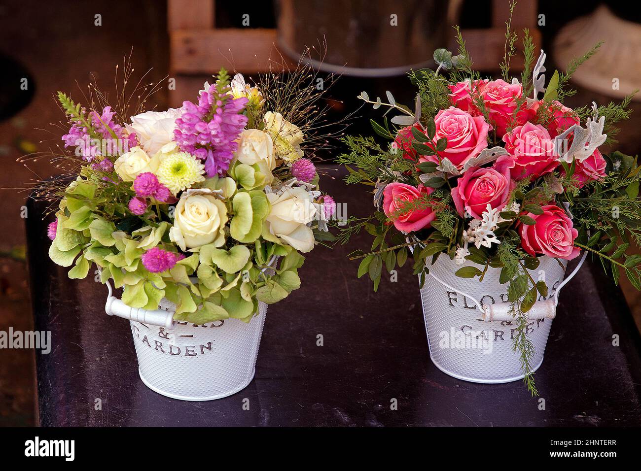 Rose flowers in metal buckets Stock Photo Alamy