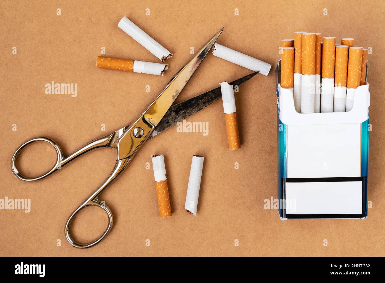 Cutting cigarettes by scissors. Anti smoking or quit smoking concept Stock  Photo