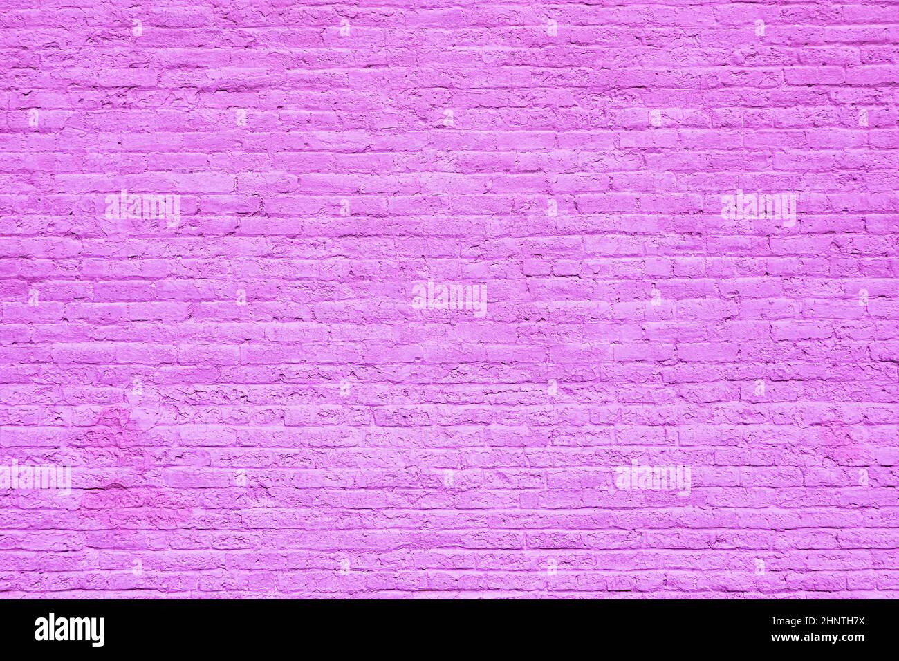 harmonic old brick wall painted in violet as background Stock Photo