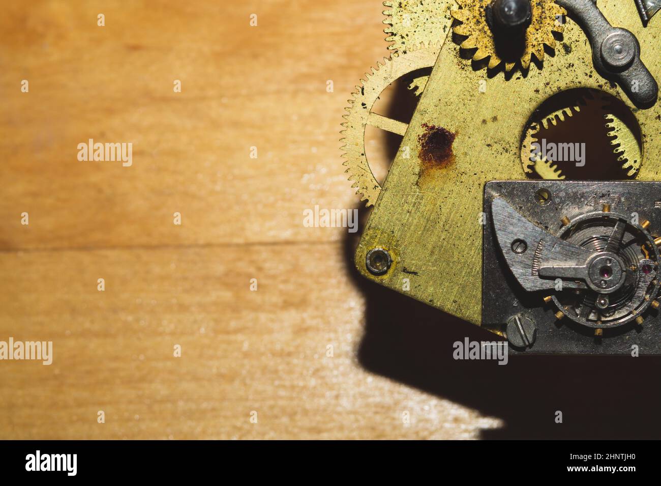 Wooden background with detail of a clock mechanism. gears of a mechanical watch Stock Photo