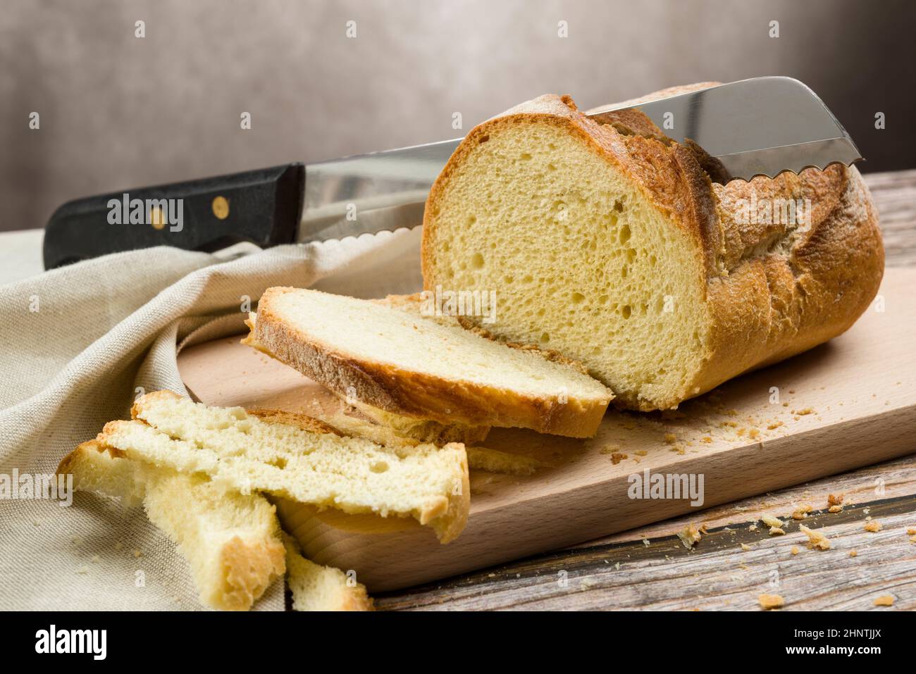 Whole grain bread on kitchen table with knife for cut Stock Photo Alamy