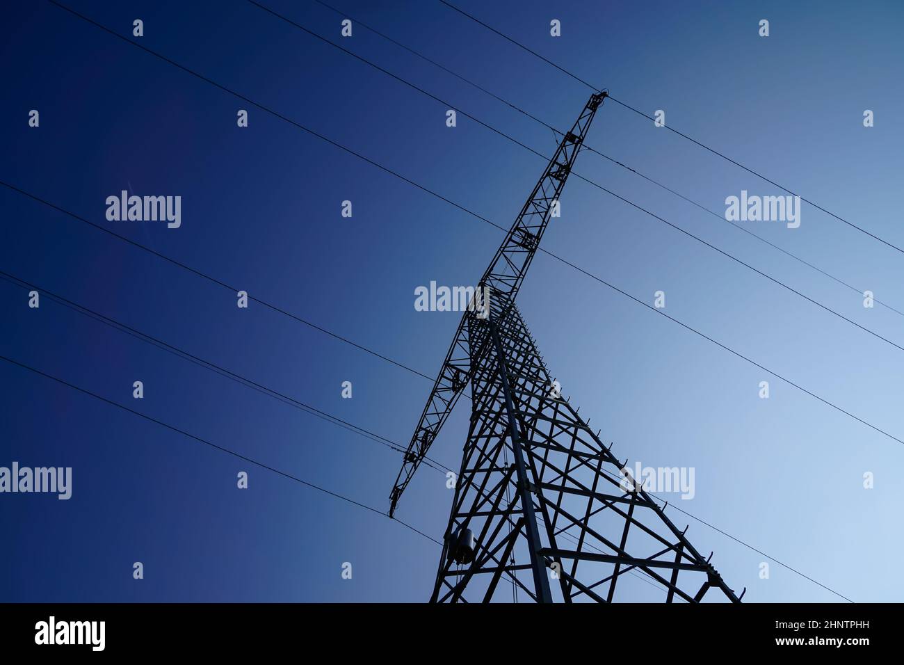 Electricity mast or overhead line mast for power supply and power distribution in the power grid Stock Photo
