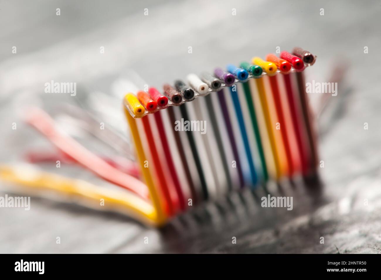 Extreme closeup of a short, bent and colorful computer ribbon cable on