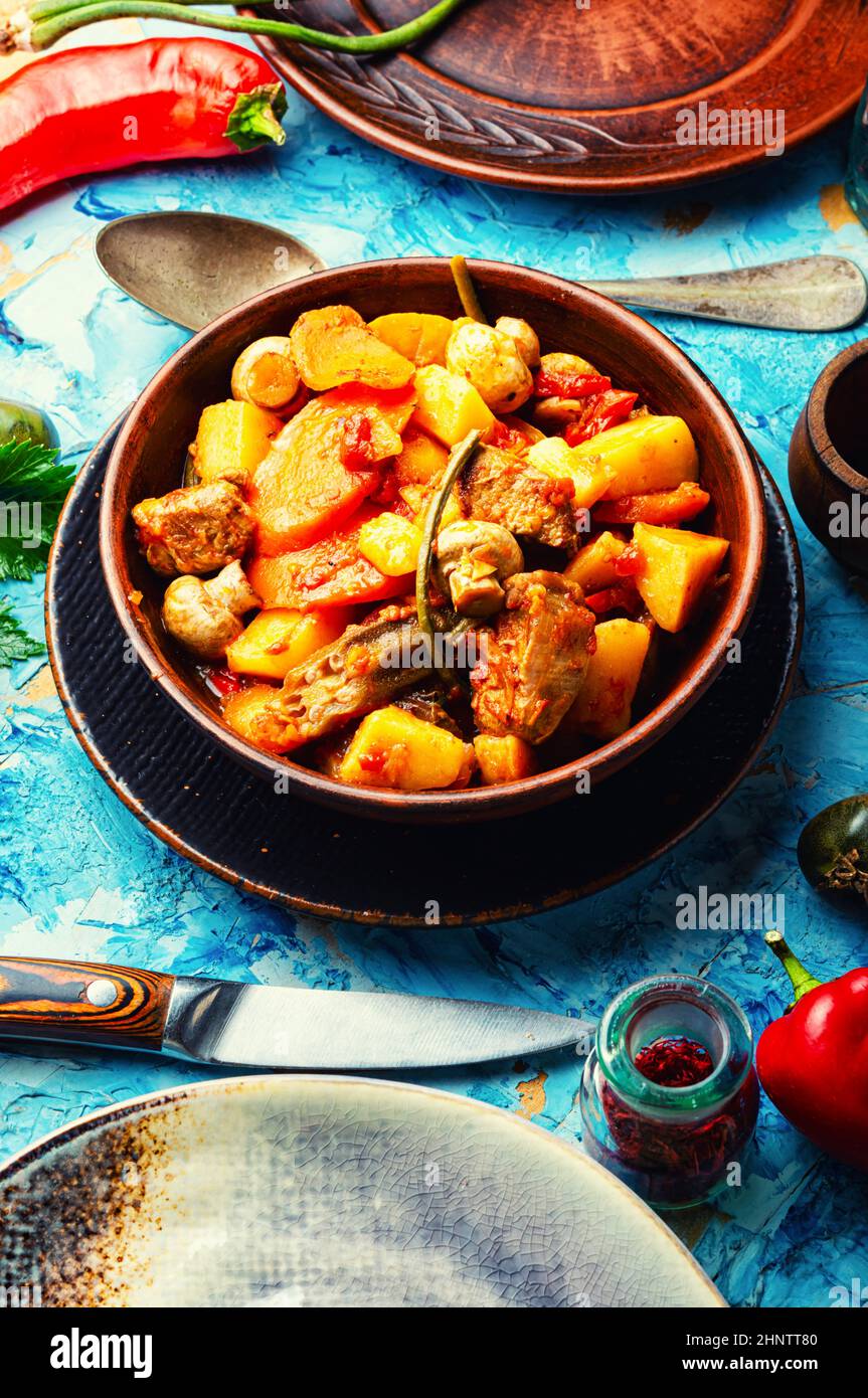 Meat ragout with mushrooms, zucchini, tomato and potatoes. Braised meat