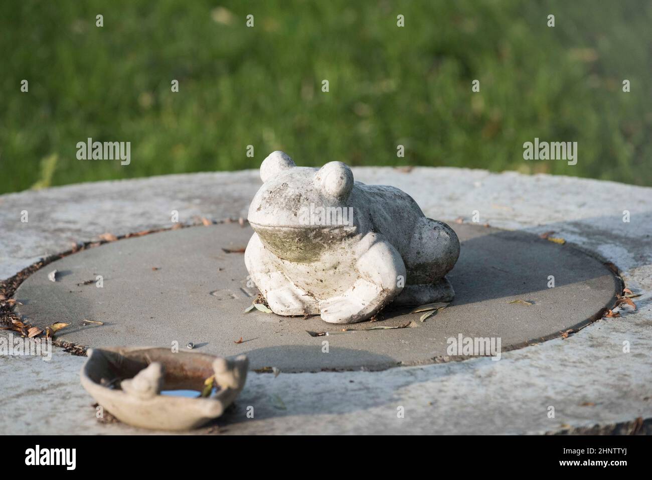 a frog made of stone, symbol of an amphibious animal Stock Photo