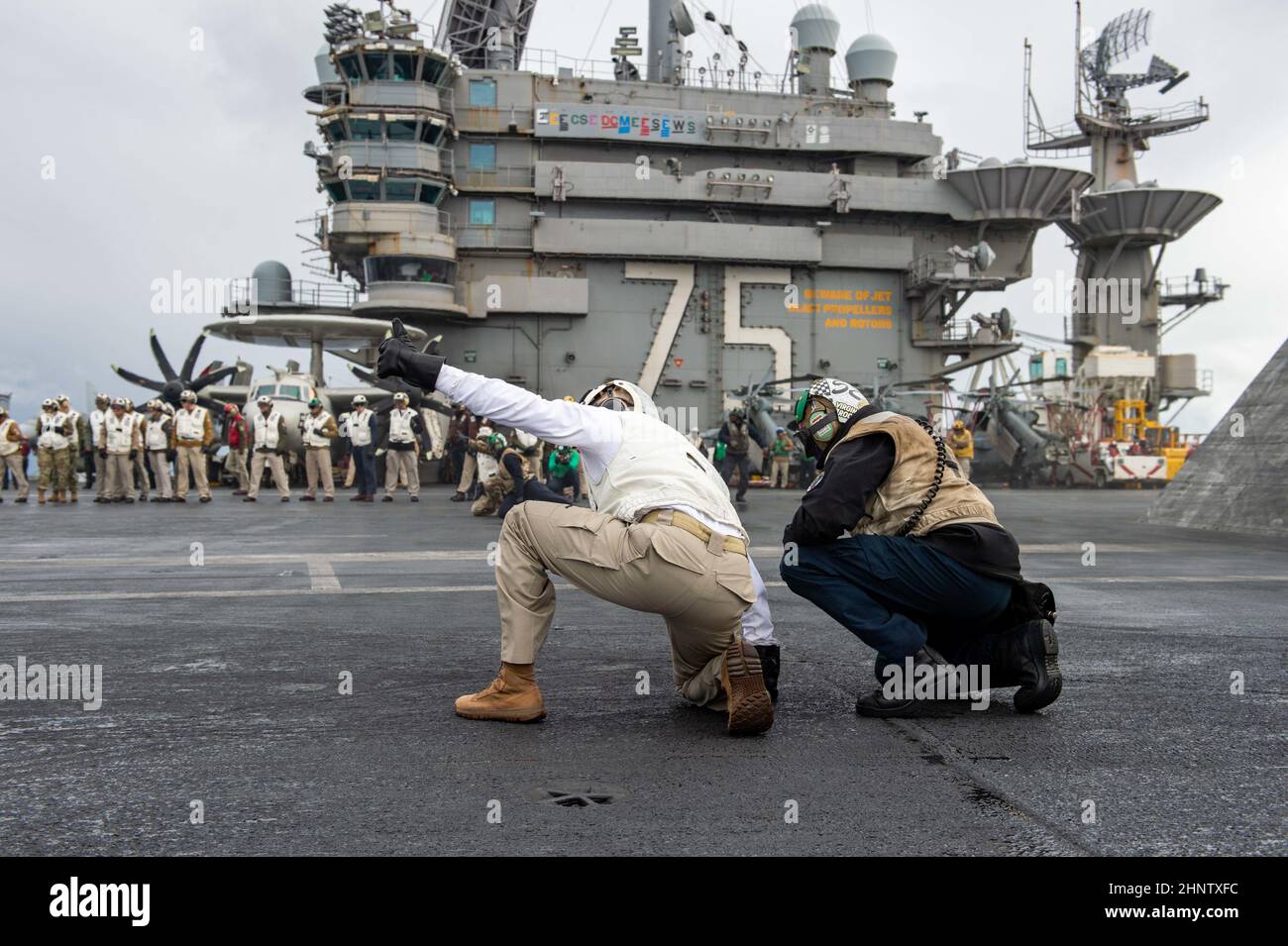 220215-N-ZE28-1625 MEDITERRANEAN SEA (Feb. 15, 2022) Fleet Master Chief Derrick Walters, fleet master chief of U.S. Naval Forces Europe and Africa, gives the signal to launch an EA-18G Growler, attached to the 'Rooks' of Electronic Attack Squadron (VAQ) 137, on the flight deck of the Nimitz-class aircraft carrier USS Harry S. Truman (CVN 75), Feb. 15, 2022. The Harry S. Truman Carrier Strike Group is on a scheduled deployment in the U.S. Sixth Fleet area of operations in support of naval operations to maintain maritime stability and security, and defend U.S., allied and partner interests in Eu Stock Photo