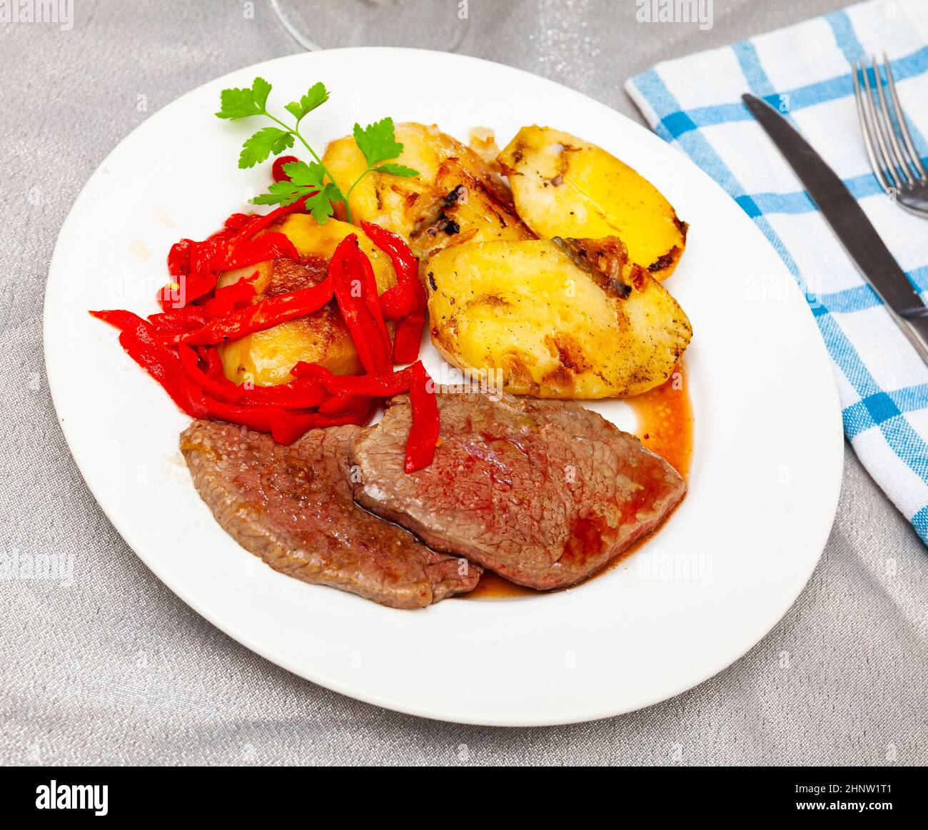 Beef steaks with baked potatoes and bell pepper Stock Photo - Alamy