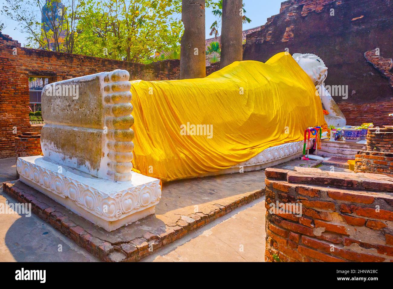 lying Buddha dressed in yellow scarf in temple Wat Yai Chai mongkol near Ayutthaya Stock Photo