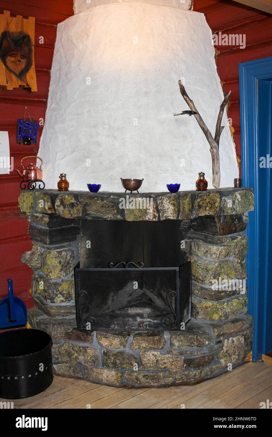 Old stone and wood fireplace in a Norwegian cabin in Hemsedal. Stock Photo