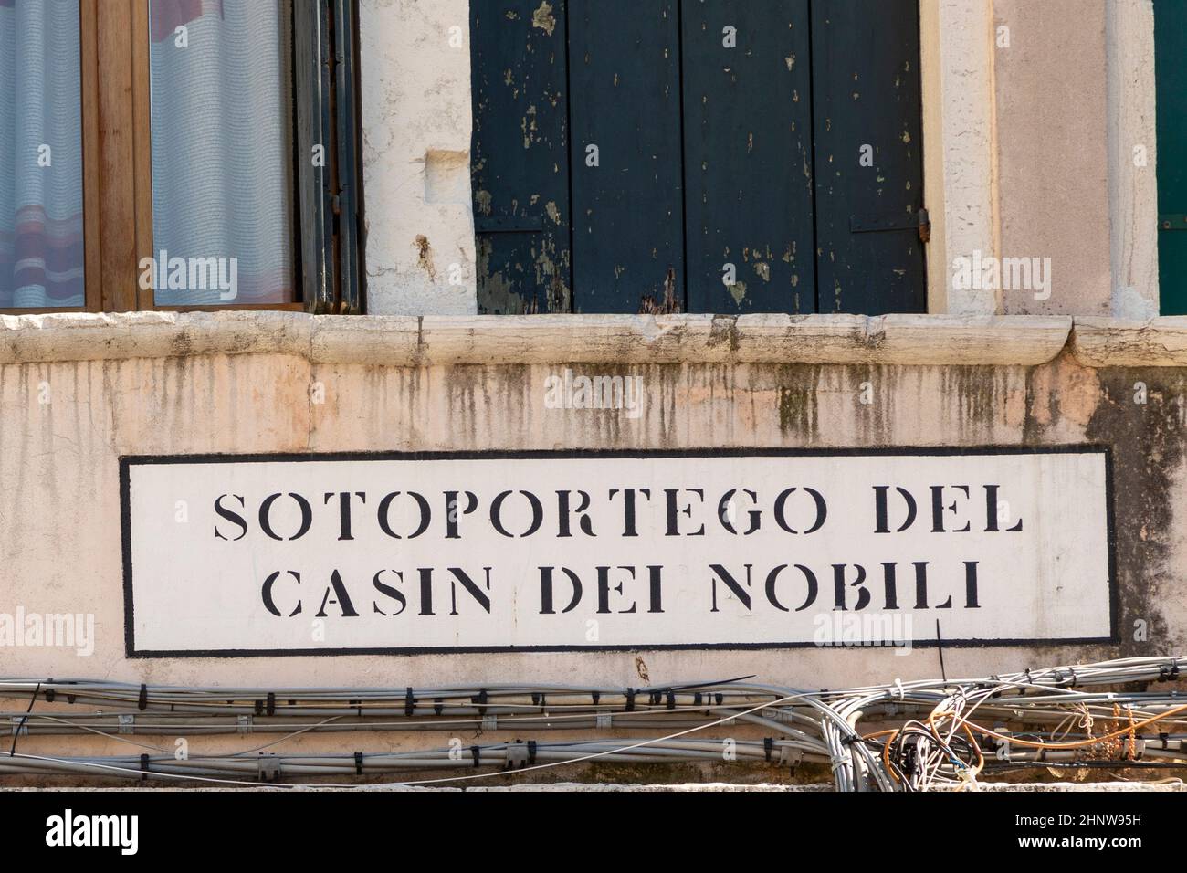 signage  Sotoportego del Casin dei Nobili (english: passage to place of the nobles) in Venice at an old grunge house wall Stock Photo