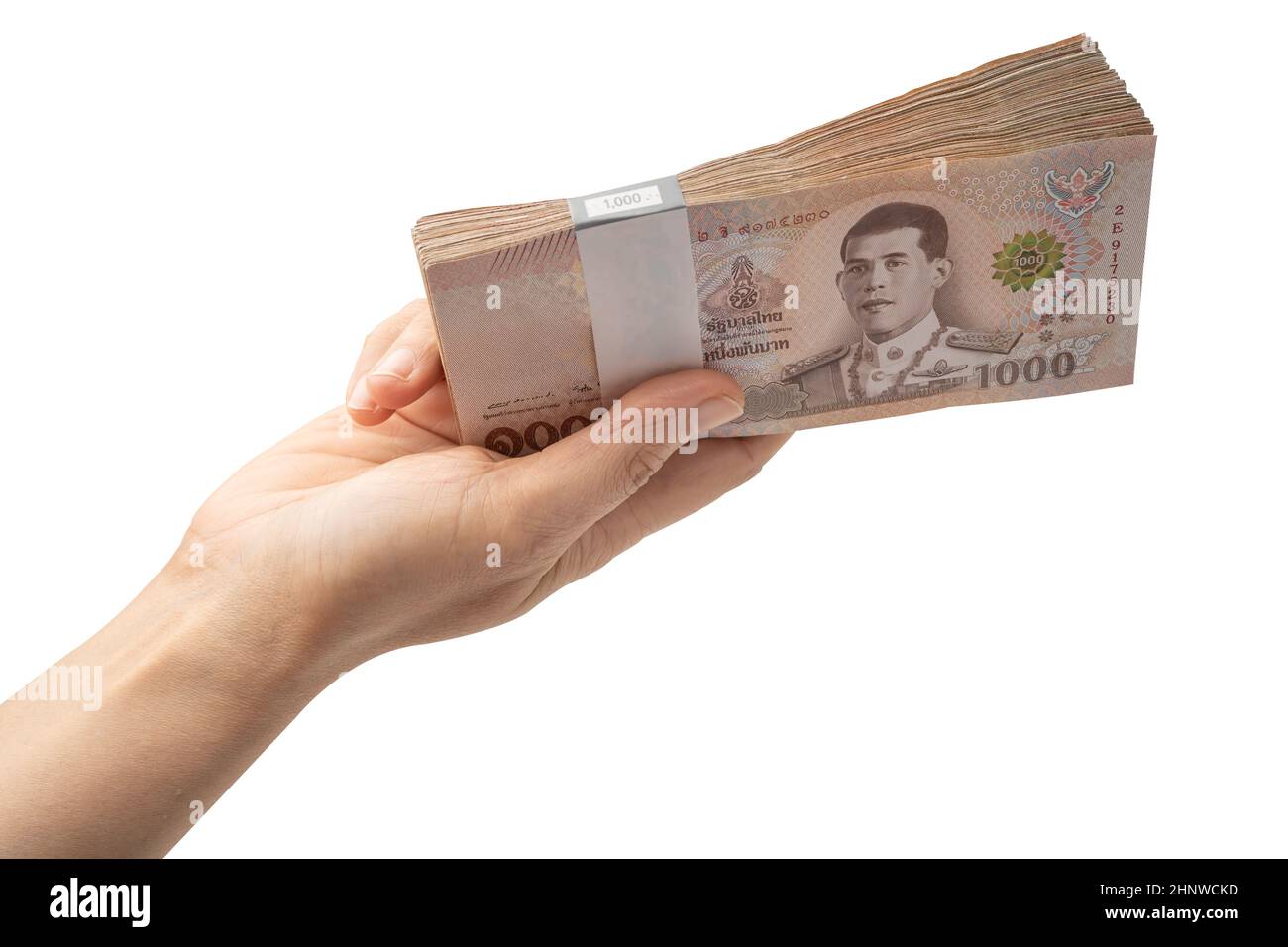 Holding stack of Thai baht banknotes on white background with clipping