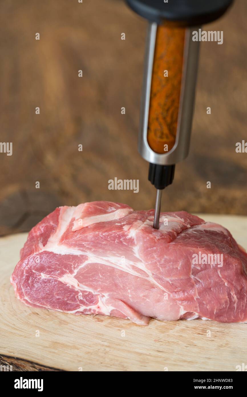 injecting marinade into pork meat Stock Photo Alamy