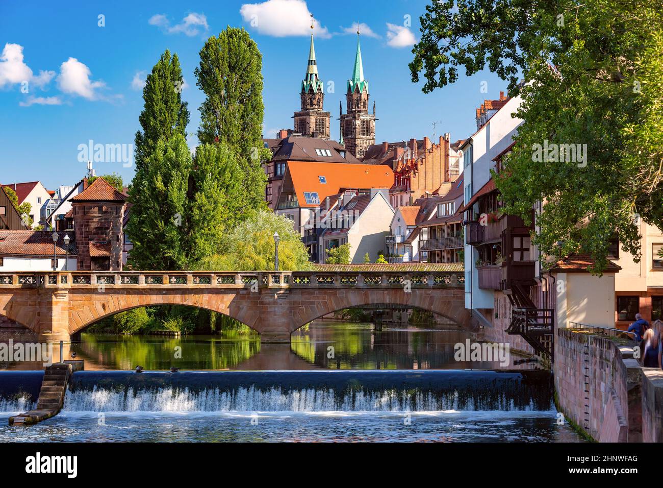 Sunny church and bridge over Pegnitz River in the Old Town of Nurnberg, eastern Bavaria, Germany Stock Photo