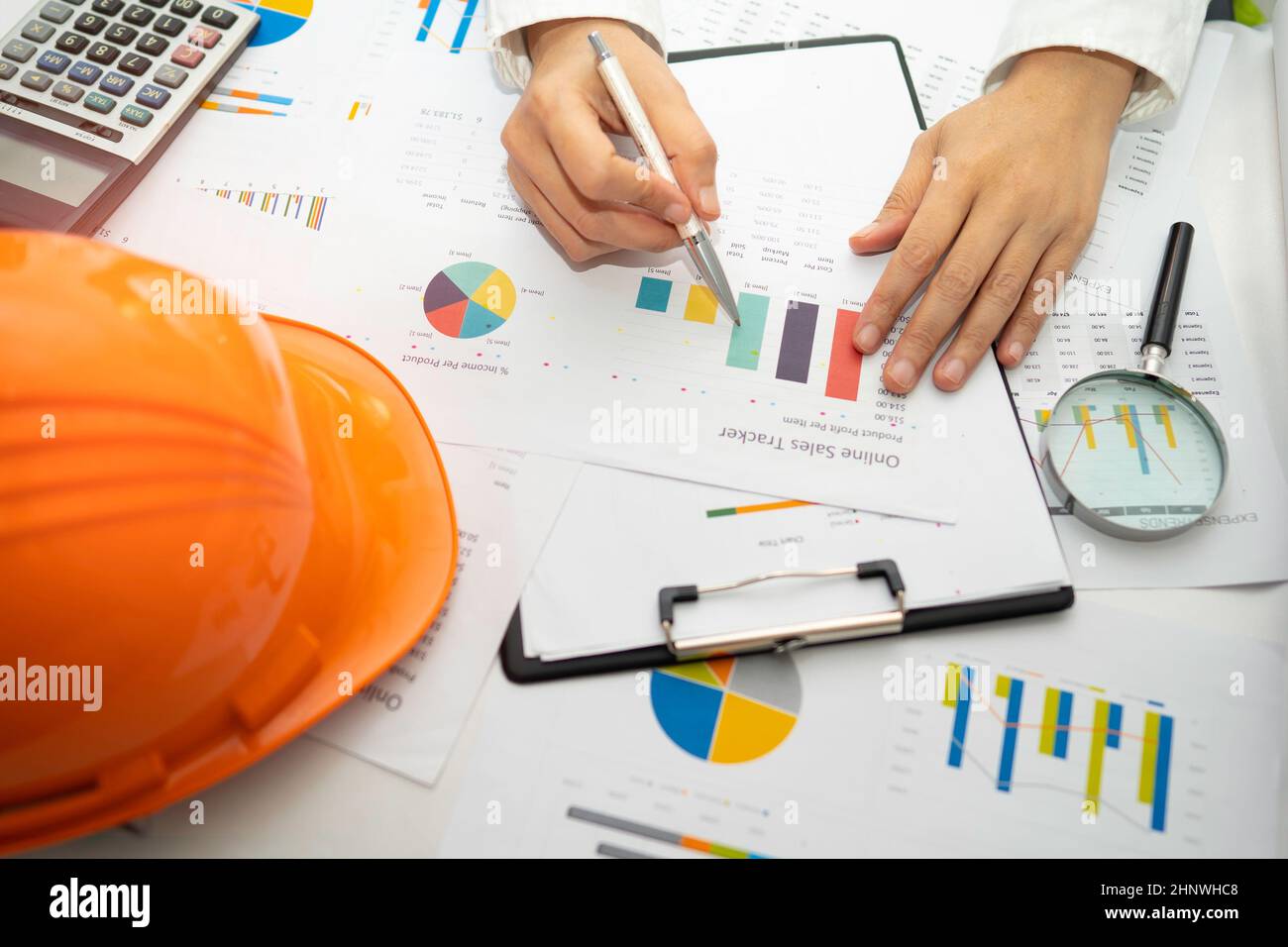 Architect or engineer working project accounting with graph with tools