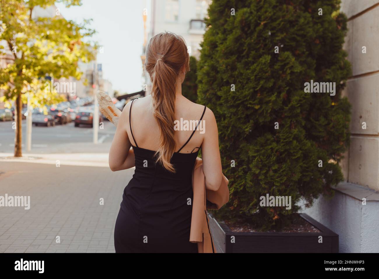 Beautiful woman in black dress walking hi-res stock photography and ...