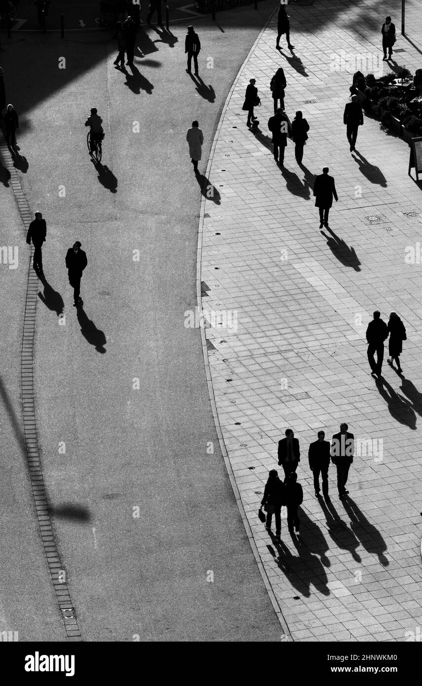 people walking at the street with long shadows Stock Photo - Alamy