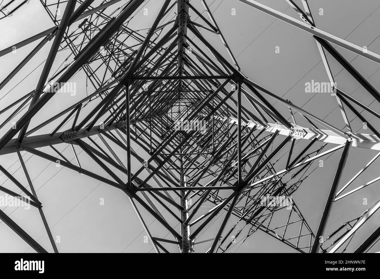 Impressive electric pylons transporting electricity through high tension cables Stock Photo