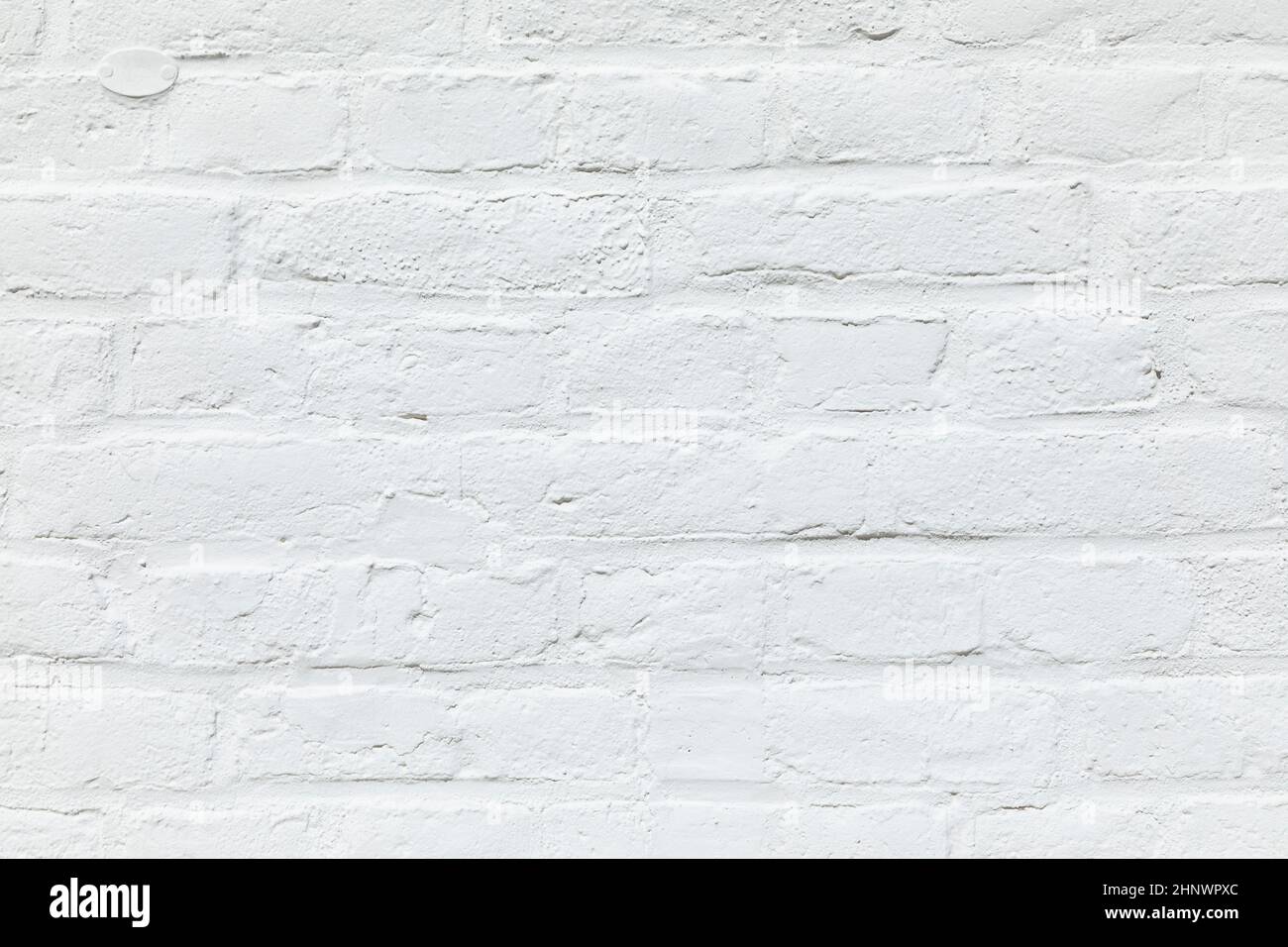 old white brick wall painted in white as harmonic background Stock Photo