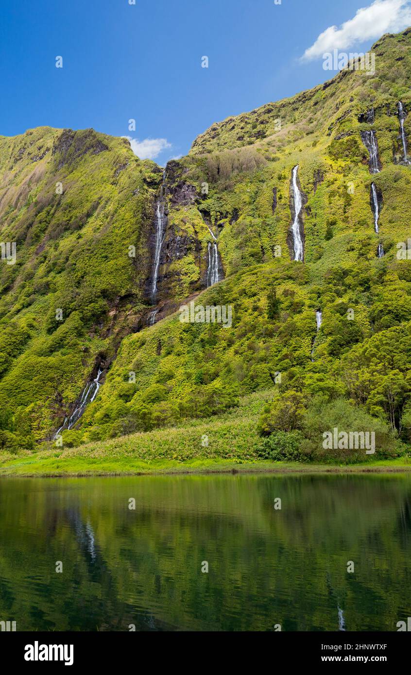 Beautiful reflection of the Poco Ribeira do Ferreiro waterfalls on Flores island in the Azores. Stock Photo