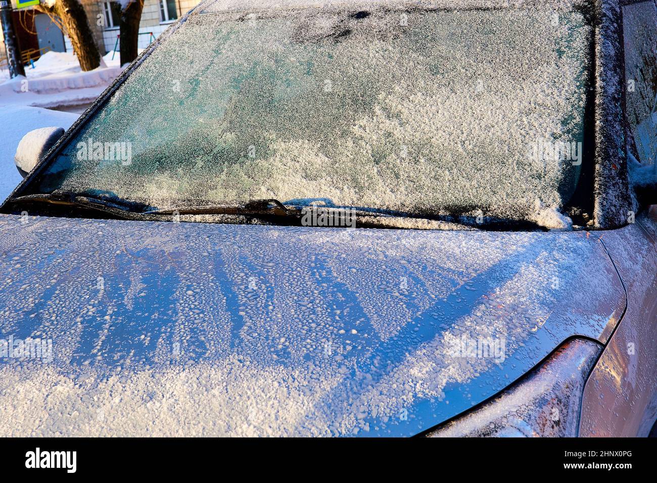 The windshield covered with frost at the car on a sun winter day Stock