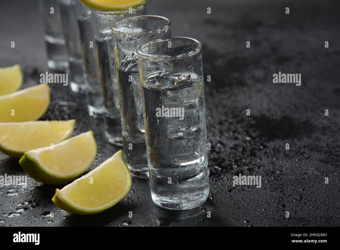 Aperitif with friends in the bar, glasses of alcohol with lime for
