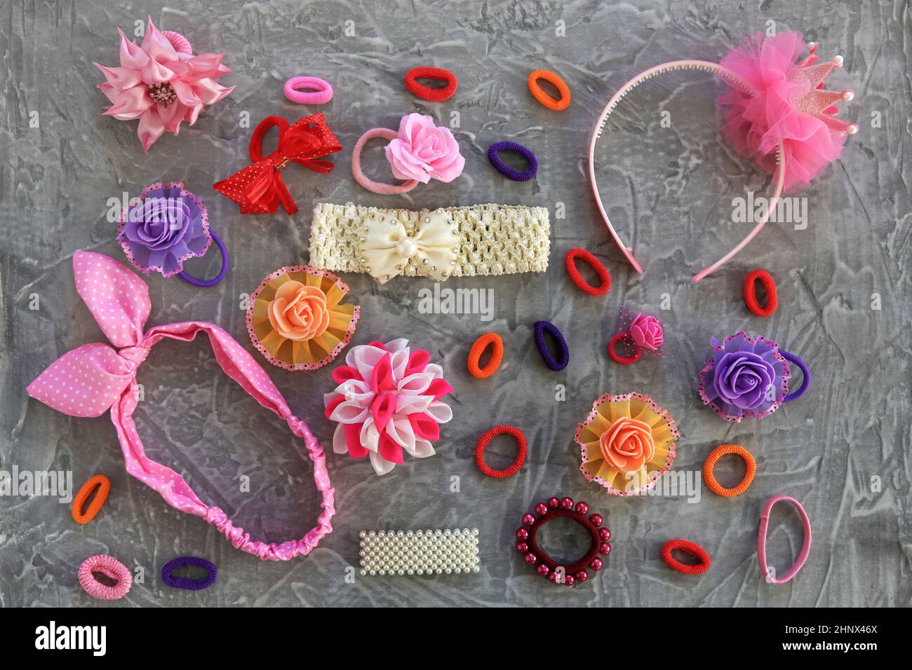 Different hair clips on gray background. Flat lay. Top view Stock Photo