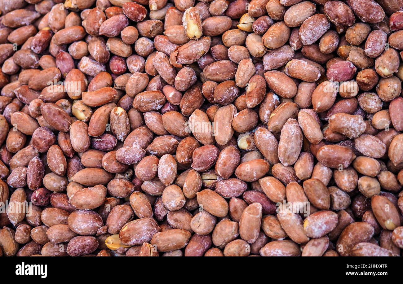 Pile of dry roasted peanuts displayed on street market, closeup detail