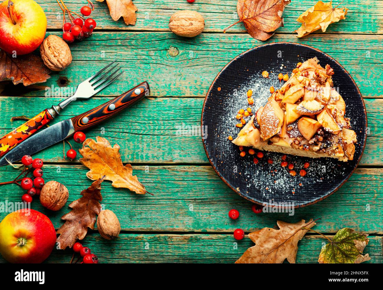 Autumn pie with apples, nuts and sea buckthorn. Charlotte on kefir. Stock Photo