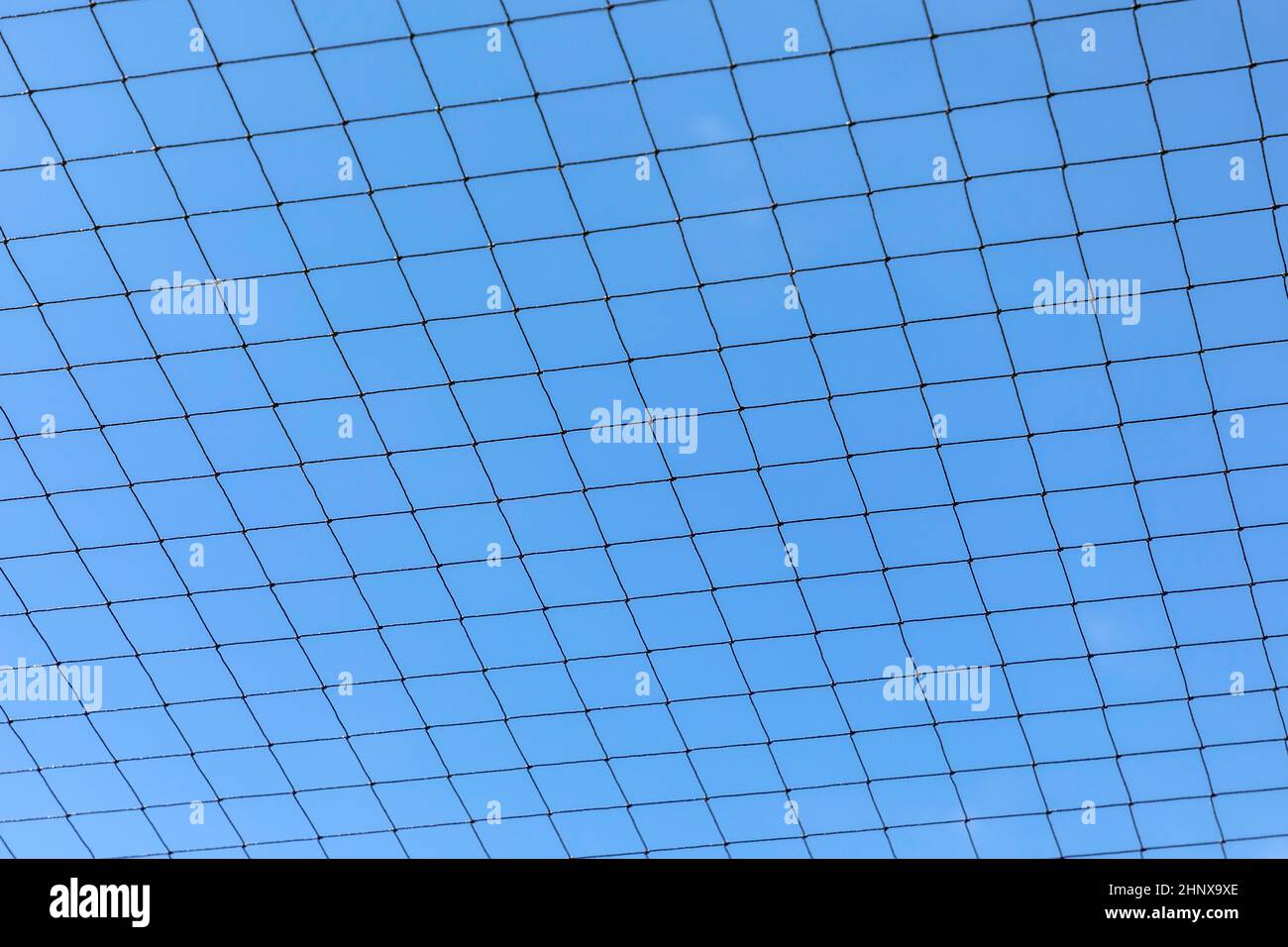 Metal Net Blue metal net with blue sky gives a harmonic background Stock Photo - Alamy